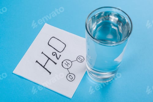 Preview: Glass with water, napkin with water formula, blue background.