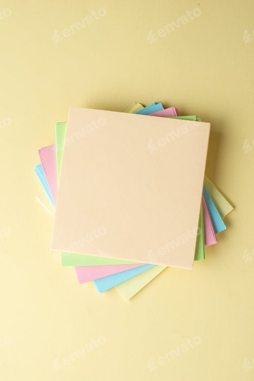 Preview: Vertical view of stacked sticky note cubes on shaded yellow background with free space