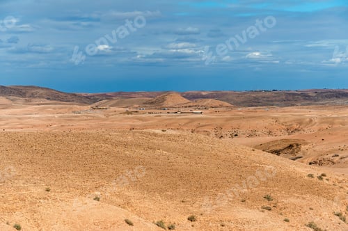 Preview: Panoramic view of Agafay village in the Moroccan desert with distant snow-capped mountains