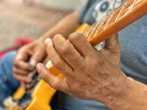 Preview: Diverse black guitarist plays music on his electric guitar on the city sidewalk