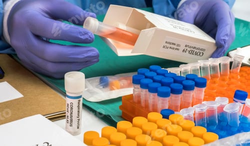 Preview: Nurse unpacking box with Covid-19 PCR kit in hospital warehouse, conceptual image