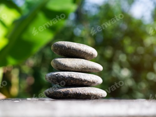 Preview: Stack Stone on Blur Plant Growth Tree wit Bokeh Background