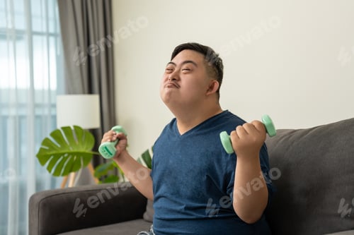 Preview: Portrait of Asian young man exercise and looking at camera in house.