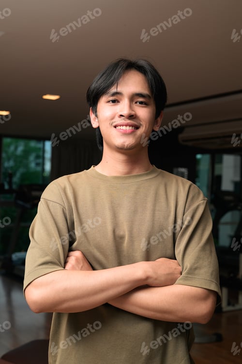 Preview: Portrait of handsome Young Asian Thai man in fitness gym at night