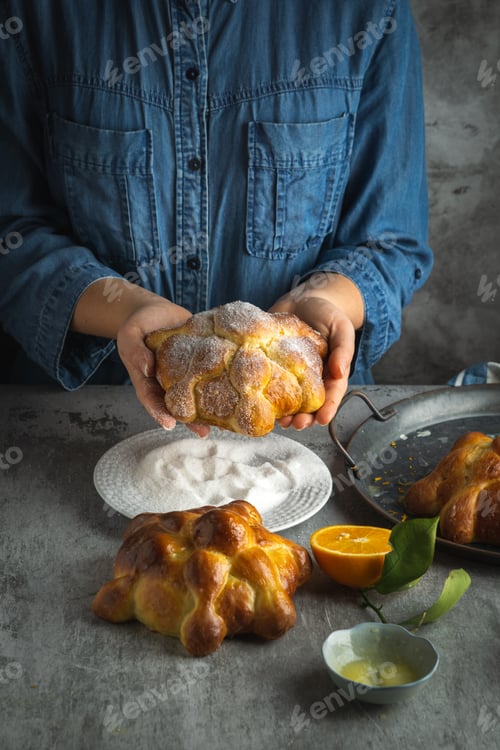 Preview: Woman preparing Pan de muertos bread of the dead for Mexican day of the dead