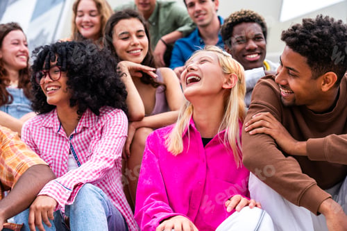 Preview: Happy playful multiethnic group of young friends bonding outdoors