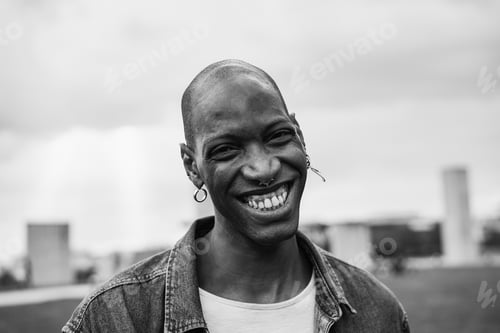 Preview: Happy african man smiling on camera outdoor - Focus on face - Black and white editing