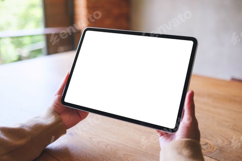 Preview: Tablet Device Displayed Over Wooden Desk Top