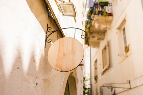 Preview: Blank signboard on stone building wall in Mediterranean alley. empty brand space