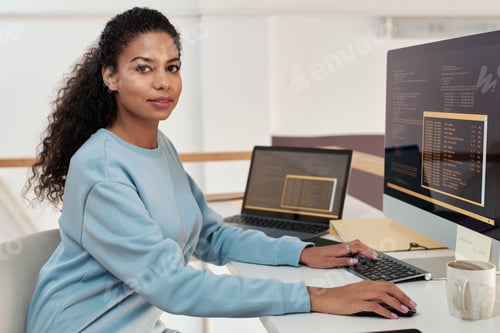 Preview: Female rogrammer working on computer in modern office of IT company