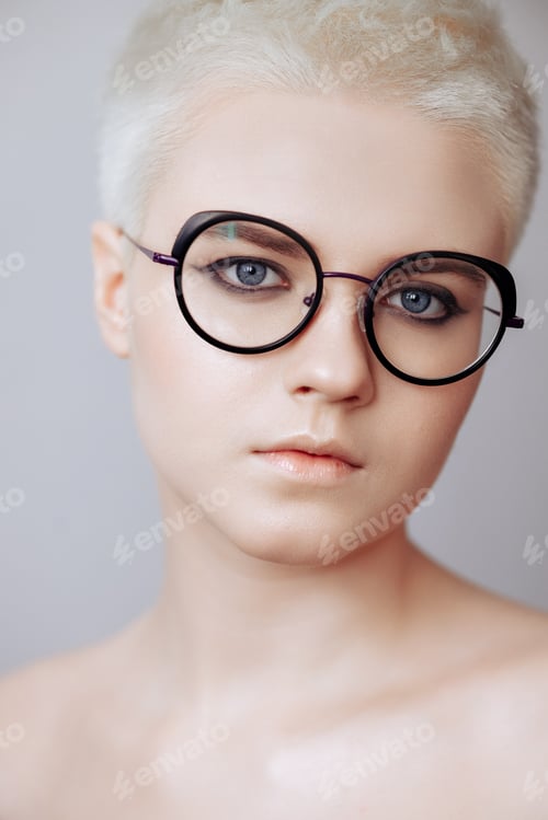 Preview: Portrait of a beautiful blonde woman with a short haircut on a white background