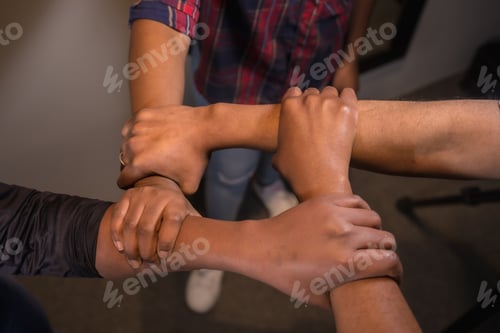 Preview: Black ethnic skin of some friends shaking hands. With a white background