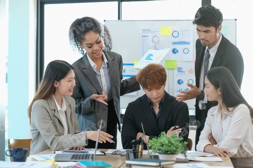 Preview: Asian business woman leader workers a paper business plan in a group meeting