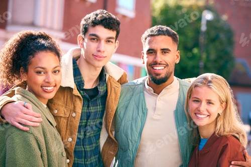 Preview: Portrait Of Multi Cultural Group Of 20 Year Old Friends Hanging Out Together In Urban Setting