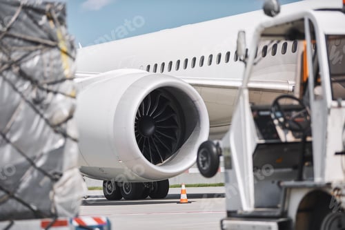 Preview: Loading of cargo containers against jet engine of plane