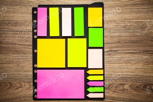 Preview: Collection colored sticky notes on wooden desk.