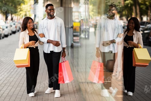 Preview: Beautiful black couple walking with shopping bags