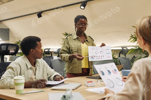 Preview: African-American Woman Giving Report in Business Meeting