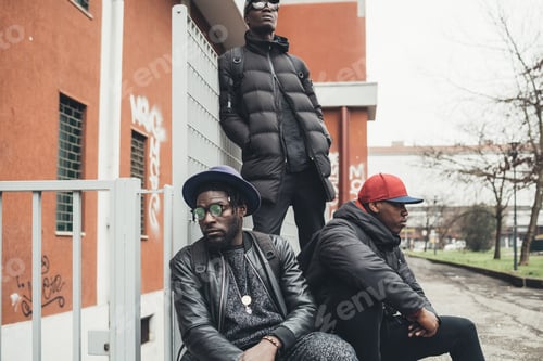 Preview: three young african men posing together in the street