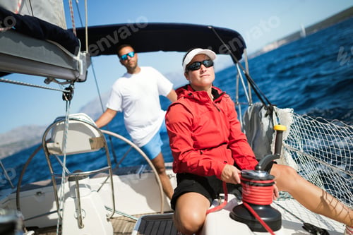 Preview: Attractive strong woman sailing with her boat