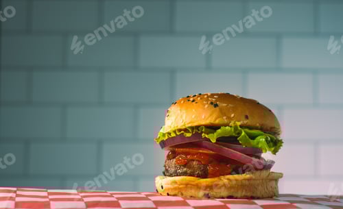 Preview: Mouthwatering Burger with Fresh Toppings on Checkered Tablecloth