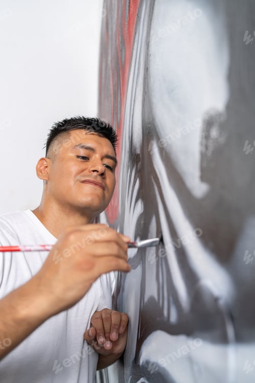 Preview: Accurate artist touches up details of a mural with a brush