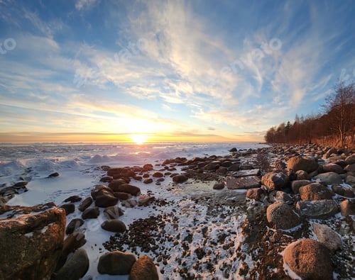Preview: Winter landscape. Panoramic view of beautiful sunset on bay. List clouds over water in bright light