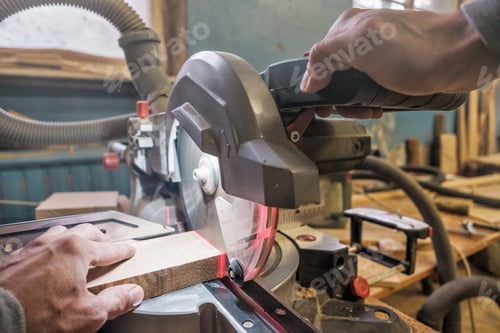 Preview: Caucasian man carpenter worker working driving circular saw to cut boards