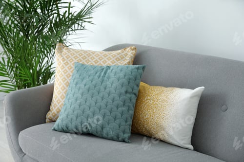 Preview: Different soft pillows on sofa in living room