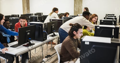 Preview: Young students using personal computer inside university IT class
