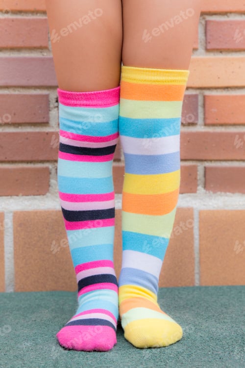 Preview: Feet of a girl with different striped colored socks
