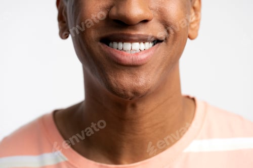 Preview: Cropped view of young smiling latin man posing with toothy smile isolated on white background