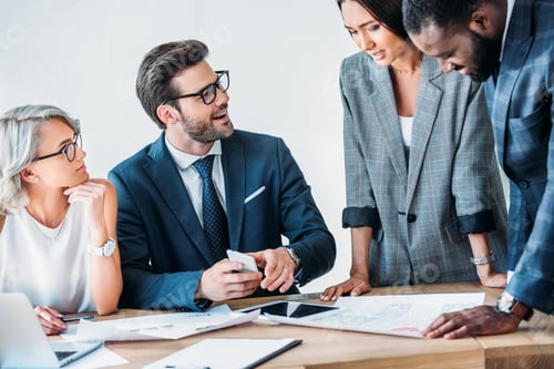 Preview: young multicultural businesspeople working on project in office