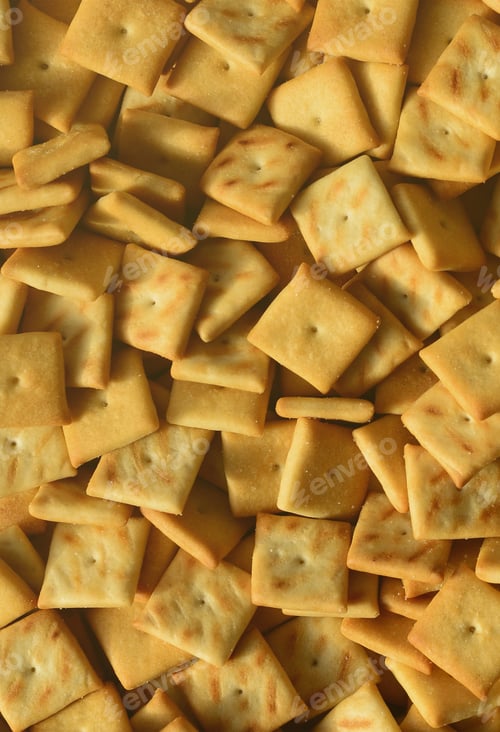 Preview: Background texture of small edible squares baked from dough and sprinkled with salt
