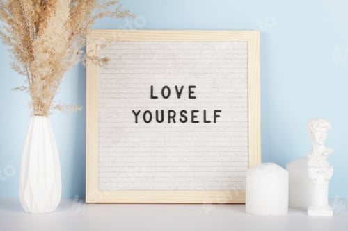 Preview: Dried pampas grass in vases, small statue, candles and felt letter board with phrase Love yourself
