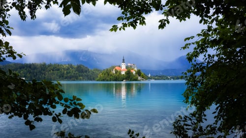 Preview: Scenic shot of the church on Bled island with its reflection on Bled lake surface
