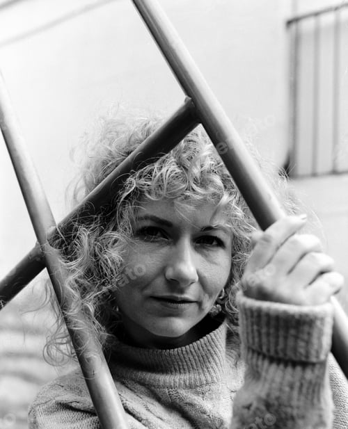 Preview: Serene portrait of curly woman in black and white.