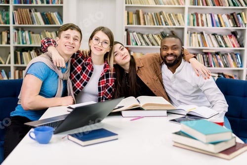 Preview: Good-looking smiling happy mixed race friends, students, coworkers, sitting at the table in modern