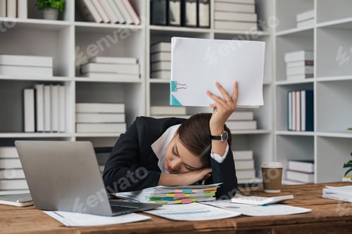 Preview: tired business woman sleepy and bored from sitting at a desk for a long time and has office