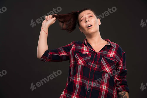Preview: Female model playing with her ponytail