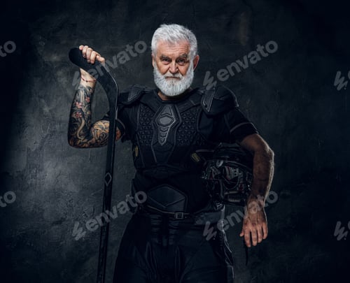 Preview: Handsome old man hockey player dressed in protective sportswear