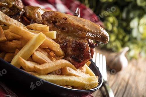 Preview: Baked chicken wings with french fries.