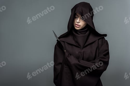 Preview: woman in death costume holding knife isolated on grey