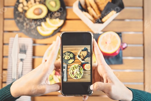 Preview: Top view female hands taking photo with mobile smartphone on heath lunch food