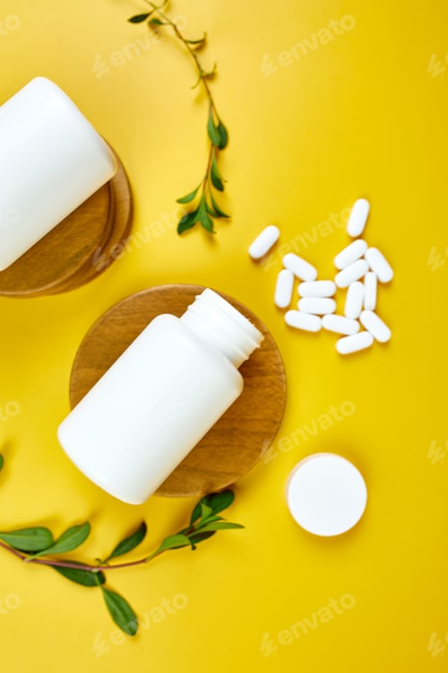 Preview: Flat lay Organic medical pills with herbal plant on a yellow background