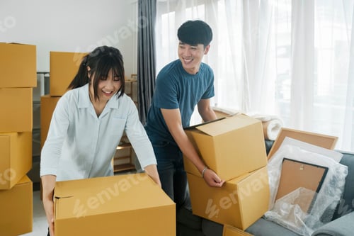 Preview: Asian young happy new married couple moving to their new house or real estate.