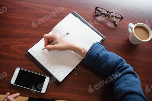 Preview: Woman writing in diary