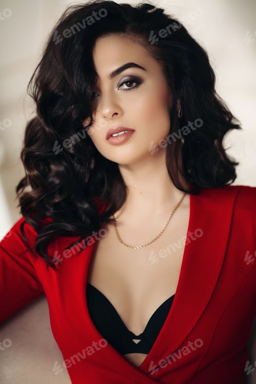 Preview: Sexy brunette woman in red blazer seductive looking at camera