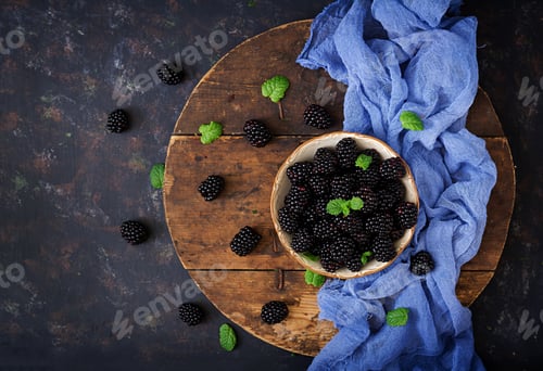 Preview: Summer berry on table. Healthy lifestyle concept, blackberries in bowl. Flat lay. Top view