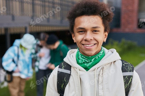 Preview: African teenage student standing outside